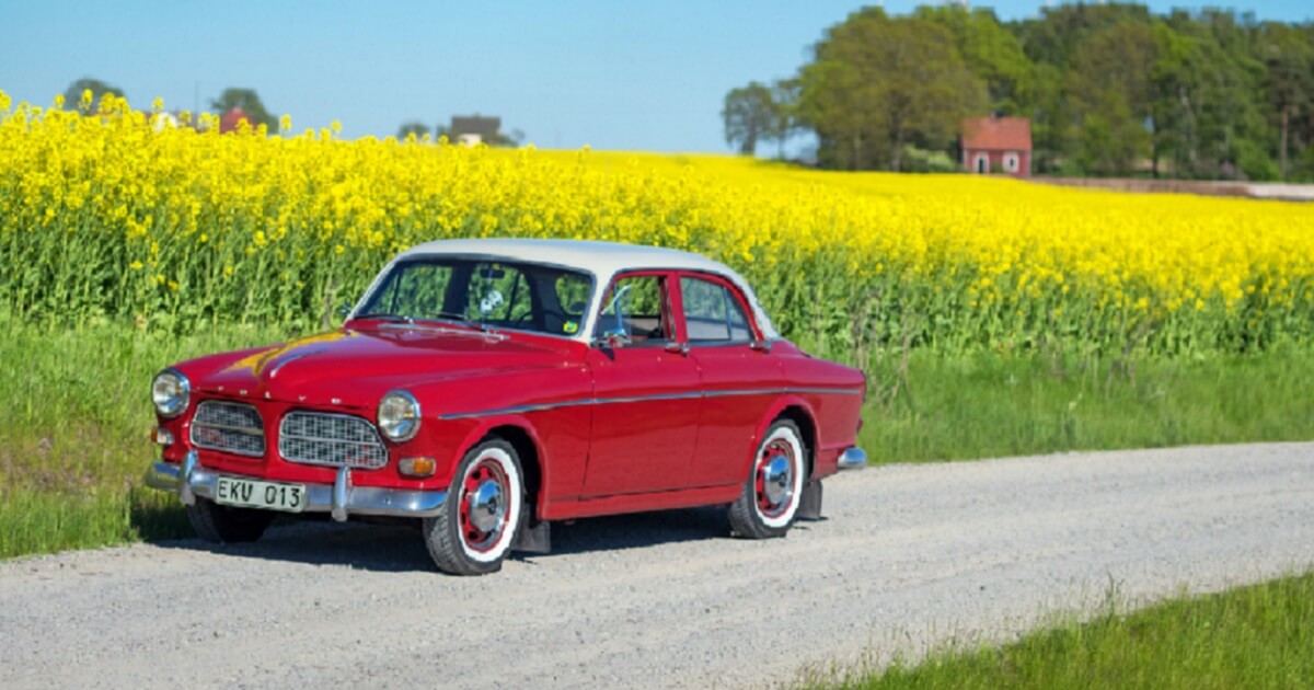 A retro Volvo is pictured on a road in southern Sweden in June 2017 with a traditional Swedish license plate
