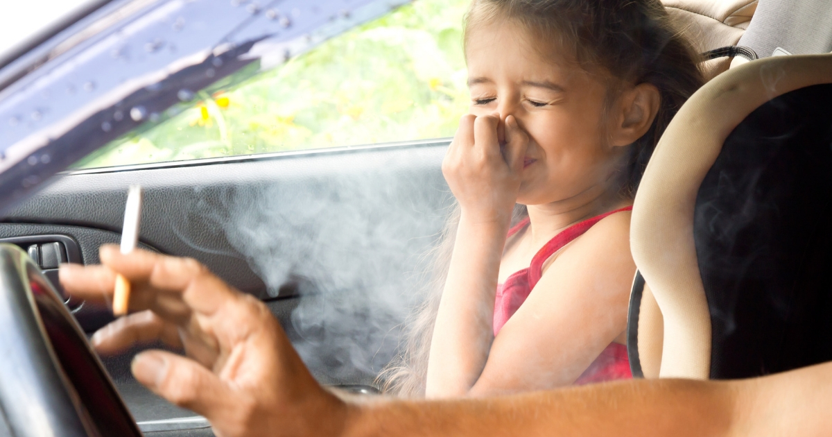 Child in car with parent smoking
