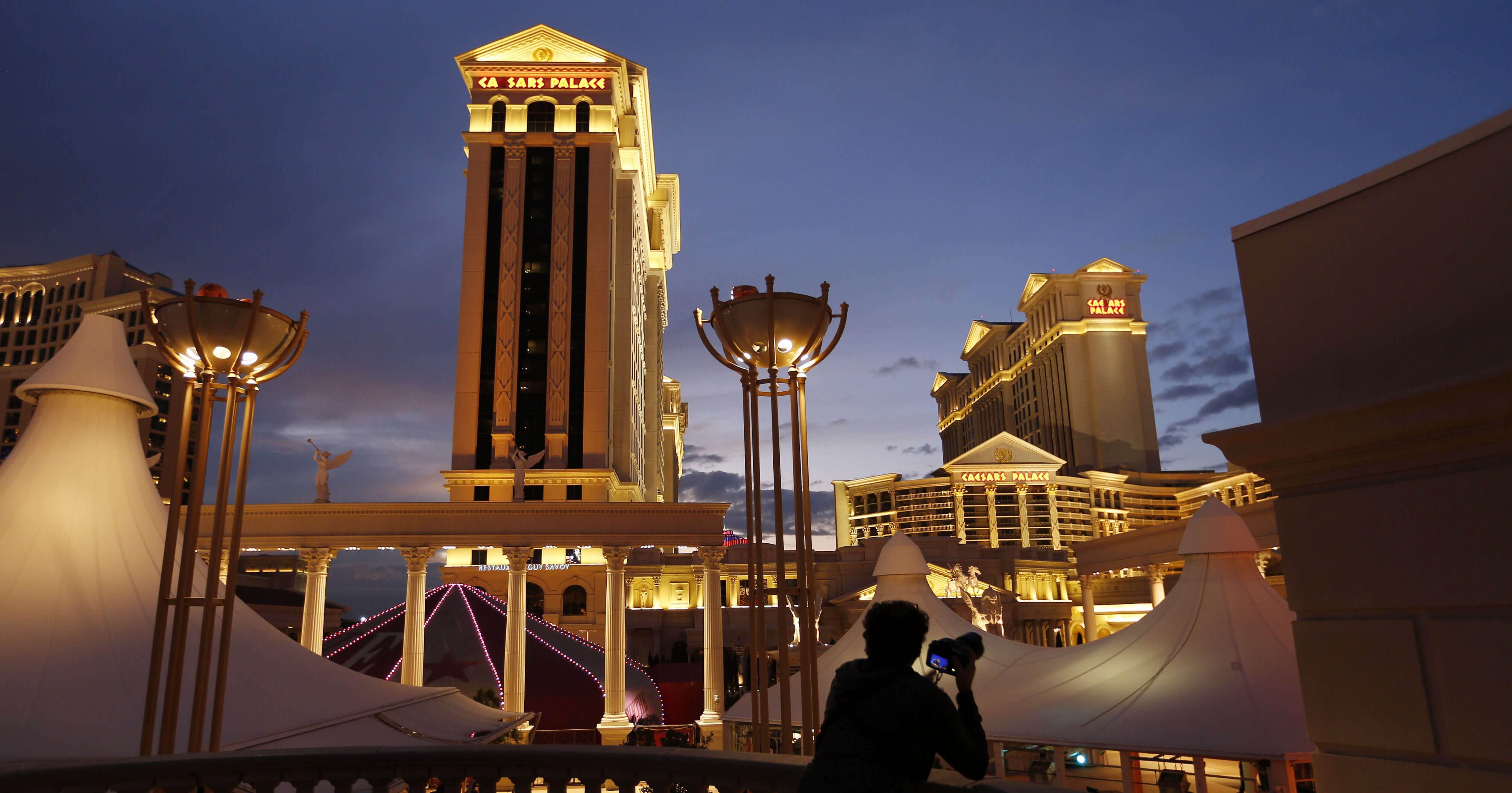 A man takes pictures of Caesars Palace hotel and casino in Las Vegas in 2015.
