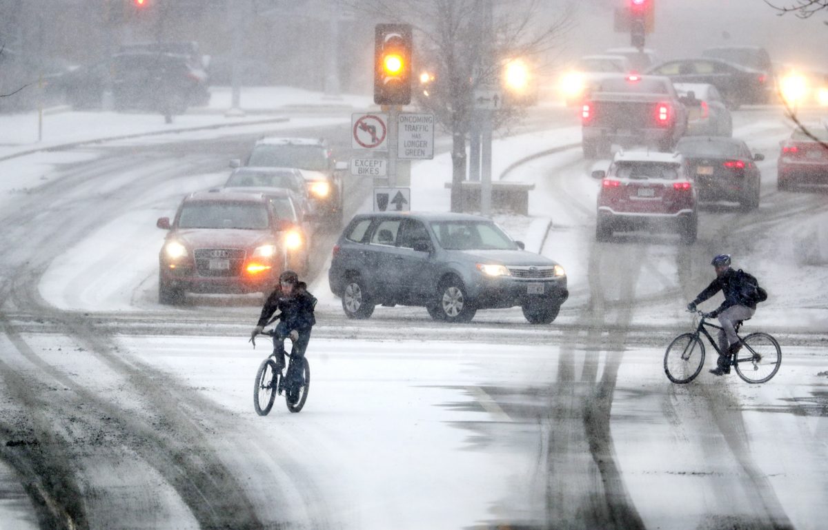 Bikers crossing Park Street at the intersection of University Ave during a late afternoon snow storm Friday, Jan. 18, 2019 in Madison, Wis.