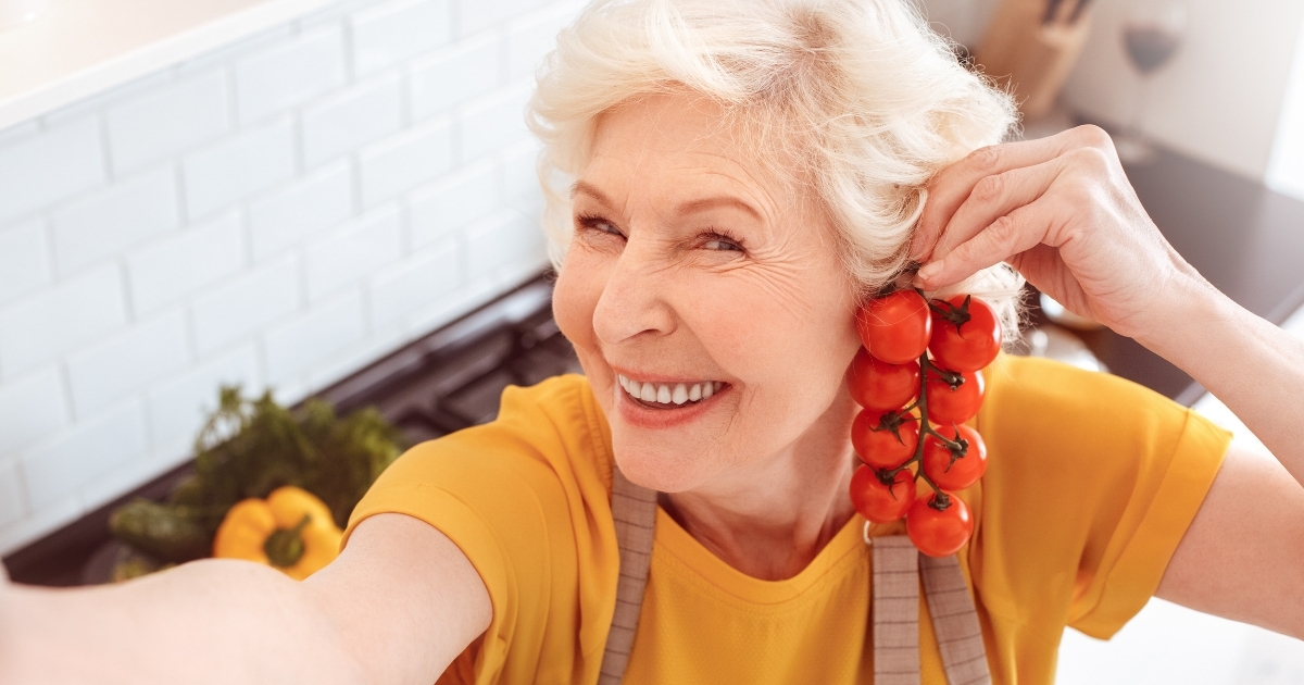 Grandma posing with tomatoes.