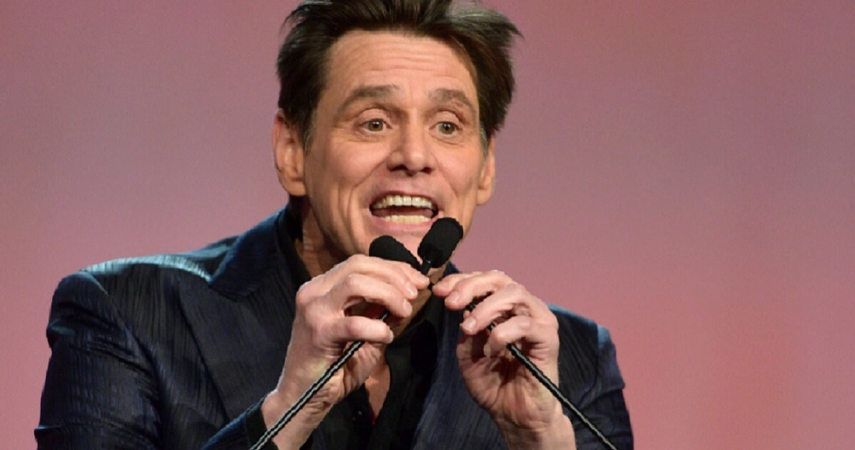 Jim Carrey makes faces into a microphone.