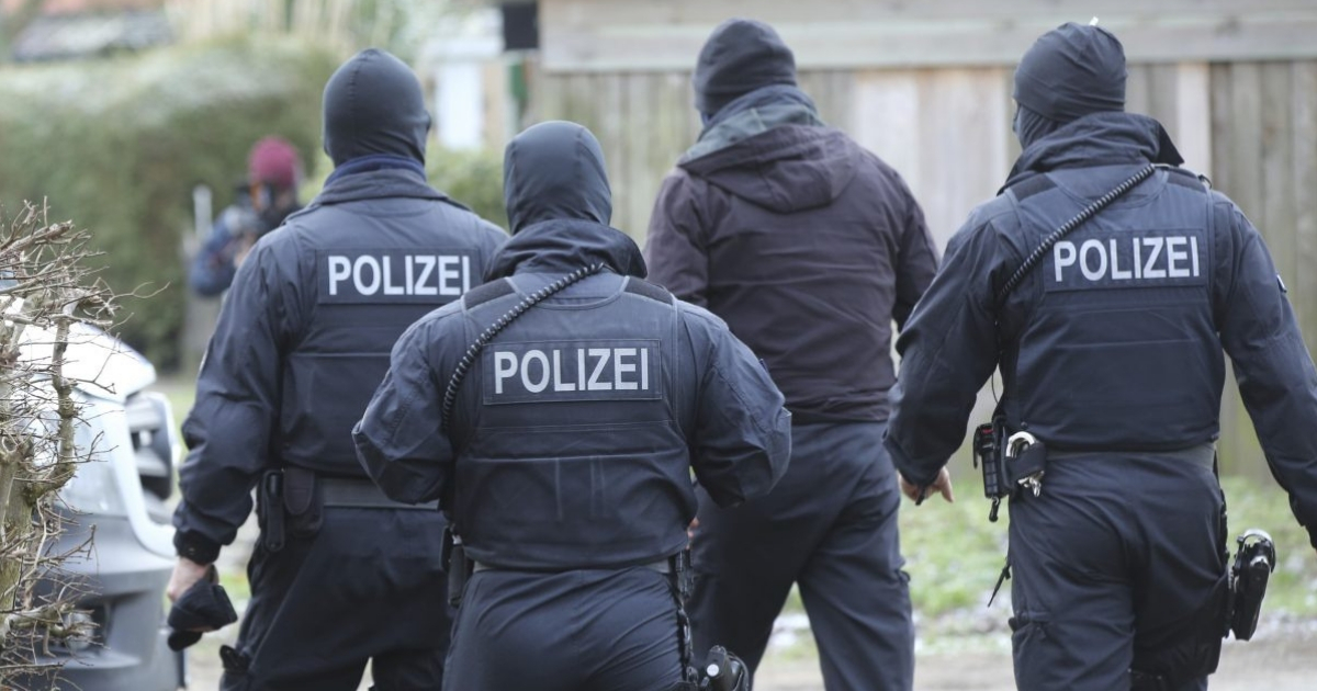 Police officer in front of at building during a raid in the village Meldorf, Germany, Jan. 30, 2019. German authorities arrested three suspected Islamic extremist Iraqi men in the norther German costal region, on allegations they were planning a bombing.