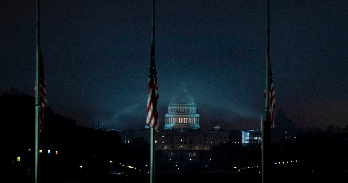 The US flag flies at half-staff in front of the Washington Monument and US Capitol.