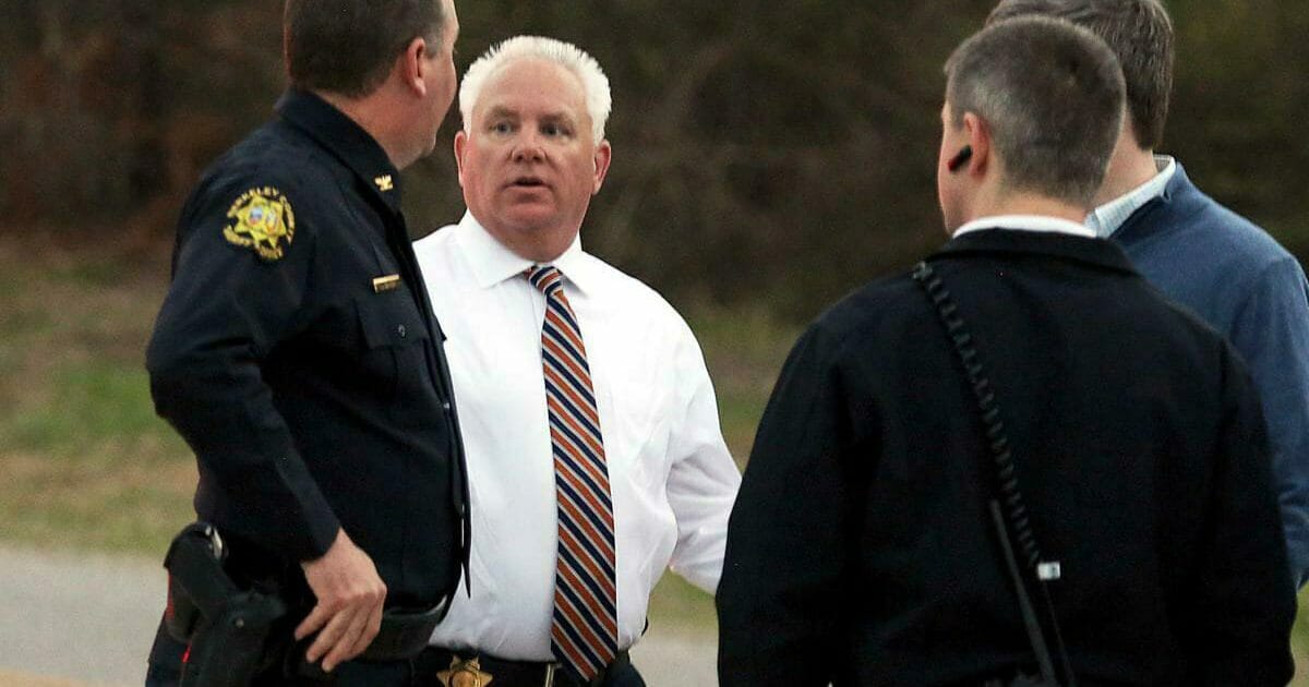 Berkeley County Sheriff Duane Lewis, second from left, talks with sheriff department personnel Tuesday after deputies and other law enforcement agents responded to an active shooter situation in Huger, South Carolina.