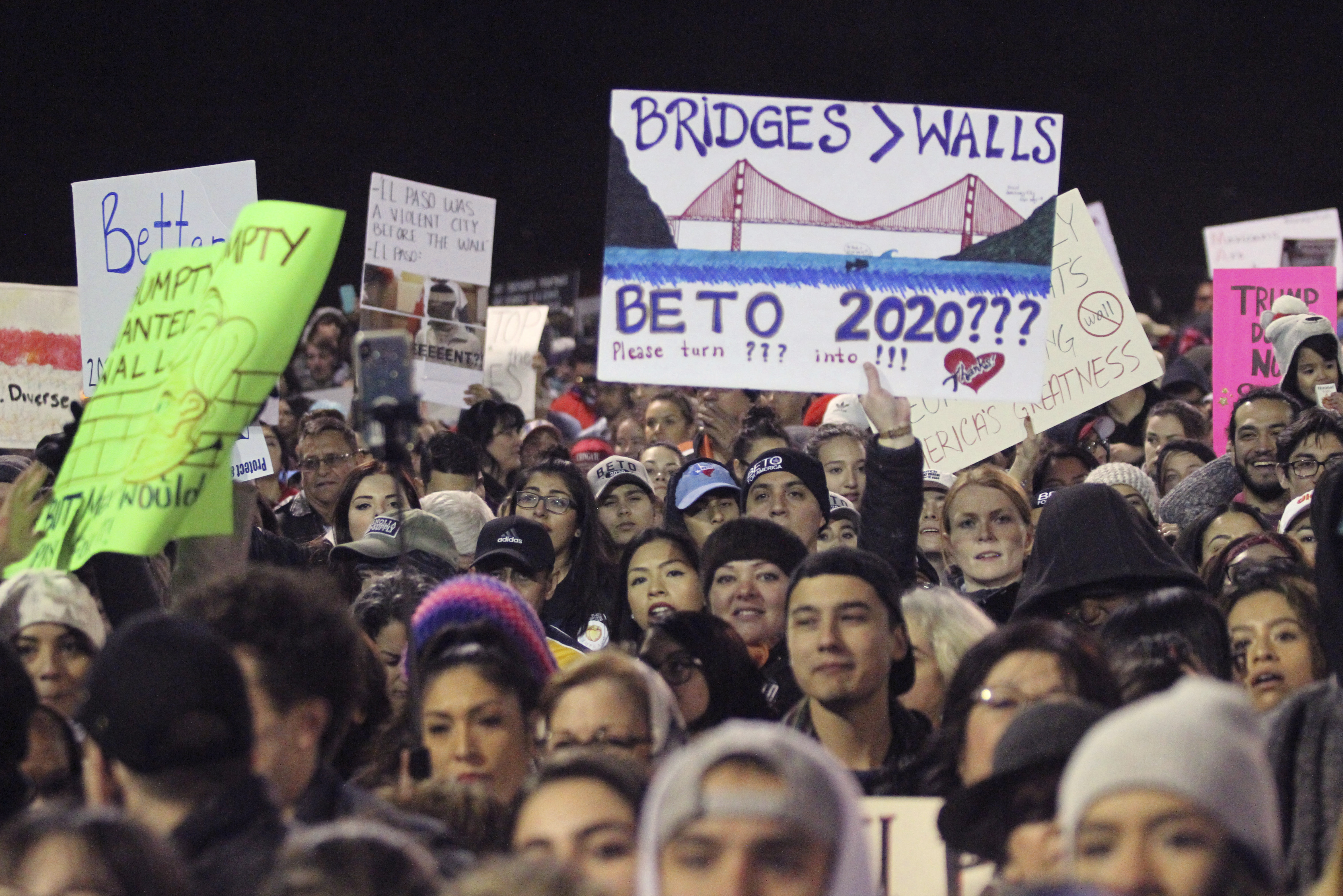 People attend an outdoor rally for former U.S. Rep. Beto O'Rourke outside the El Paso County Coliseum where President Donald Trump was holding a rally in El Paso, Texas, Monday, Feb. 11, 2019.