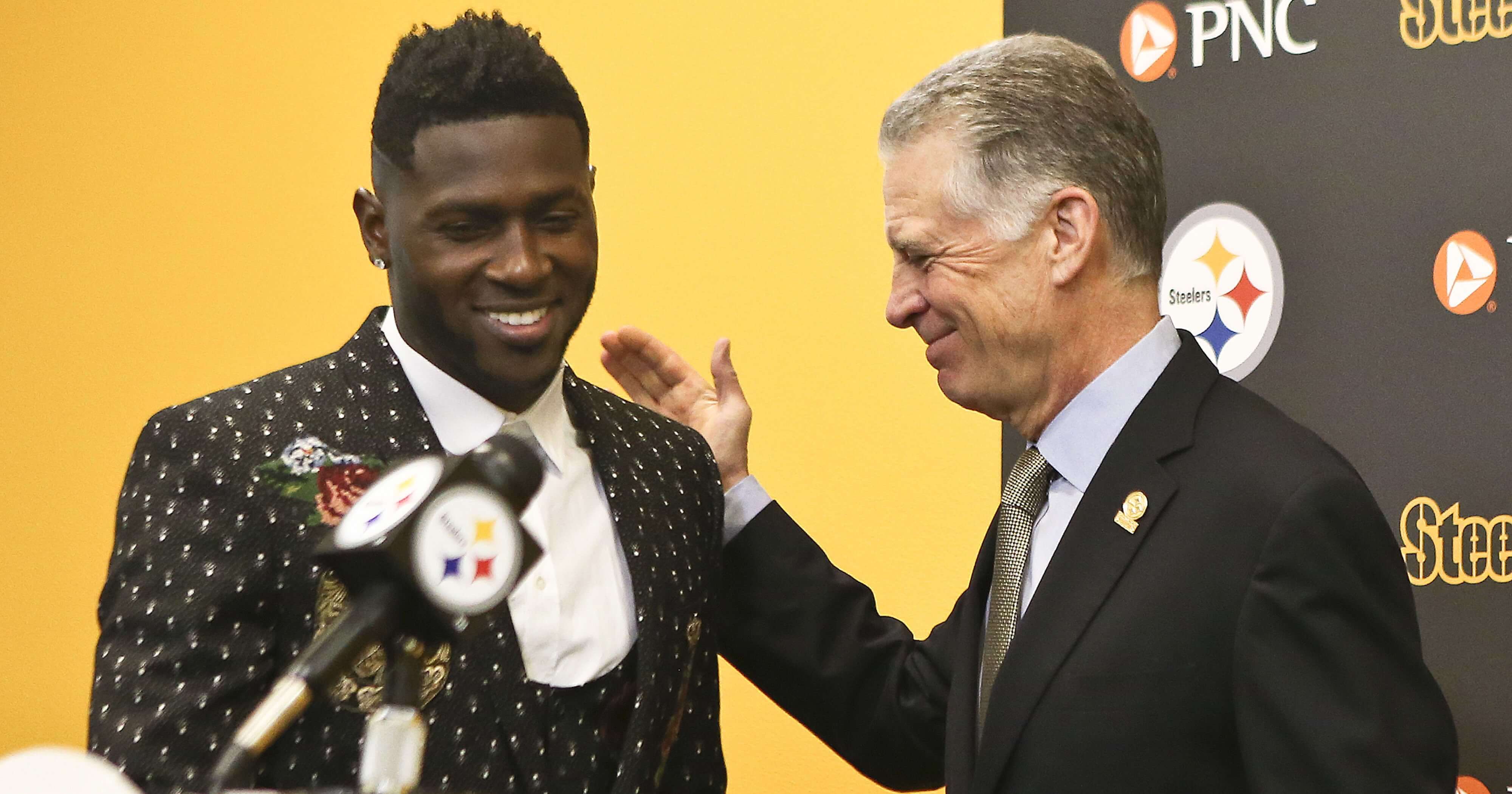 Pittsburgh Steelers wide receiver Antonio Brown, left, smiles as he is introduced by Steelers President Art Rooney II for a news conference about Brown's contract extension Feb. 28, 2017, in Pittsburgh
