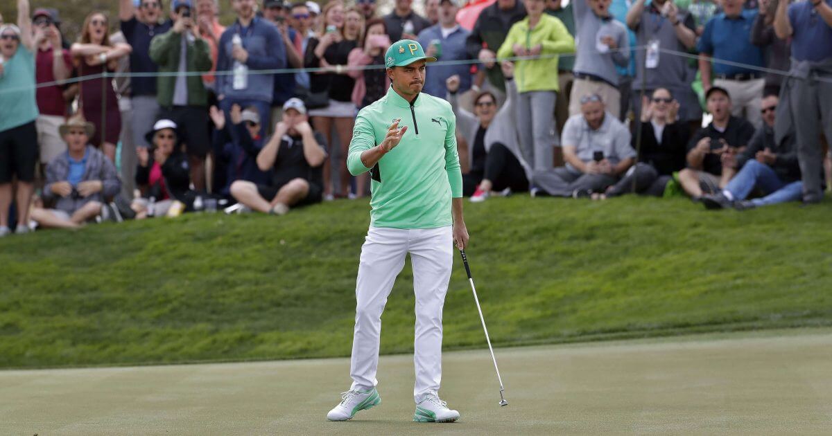 Rickie Fowler waves after making a birdie putt on the fifth green during the third round of the Phoenix Open PGA golf tournament on Saturday in Scottsdale, Arizona.