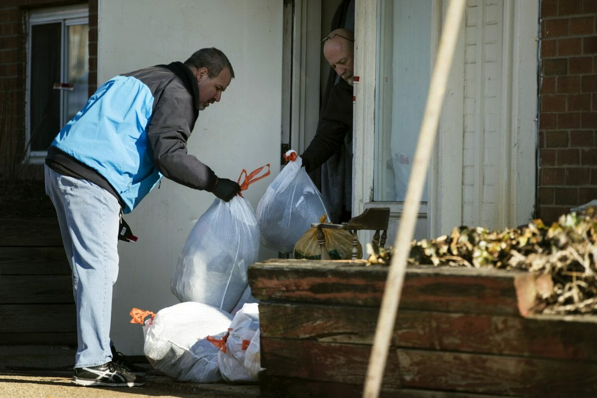 Investigators remove bags from a crime scene at the Robert Morris Apartments in Morrisville, Pennsylvania, on Feb. 26, 2019.