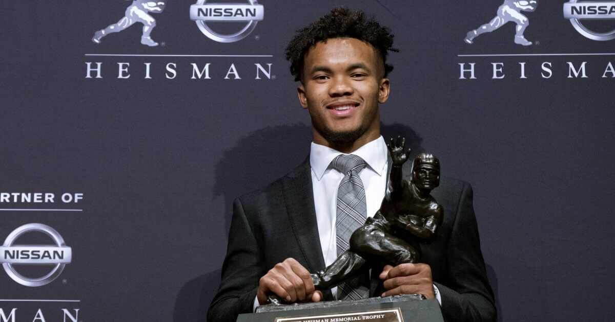Oklahoma quarterback Kyler Murray holds the Heisman Trophy after winning the award in New York in December.