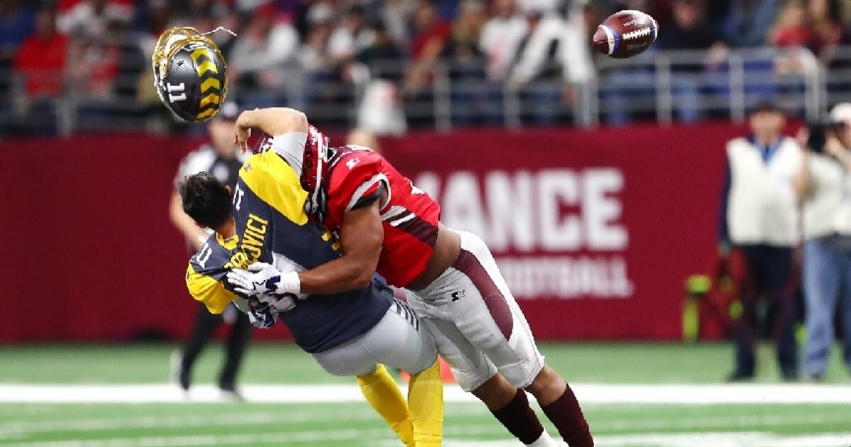 Mike Bercovici of the San Diego Fleet loses his helmet as he is tackled by Shaan Washington of the San Antonio Commanders during the first quarter in an Alliance of American Football game at the Alamodome on Saturday in San Antonio, Texas.