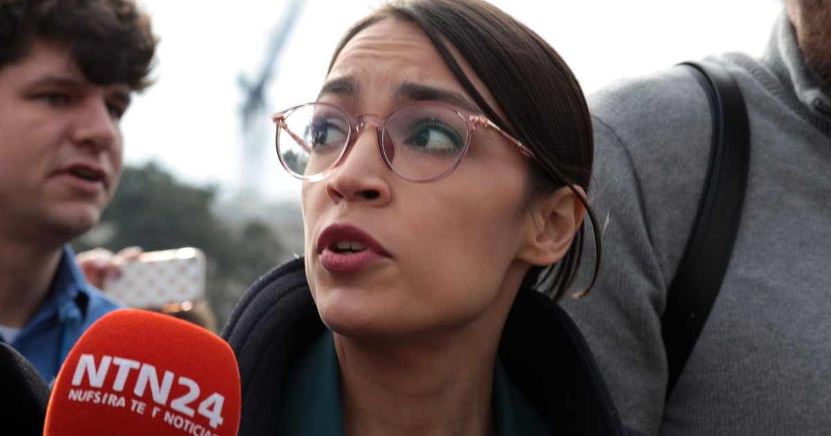 U.S. Rep. Alexandria Ocasio-Cortez, D-N.Y., is followed by members of the media after a news conference Thursday in front of the Capitol in Washington.