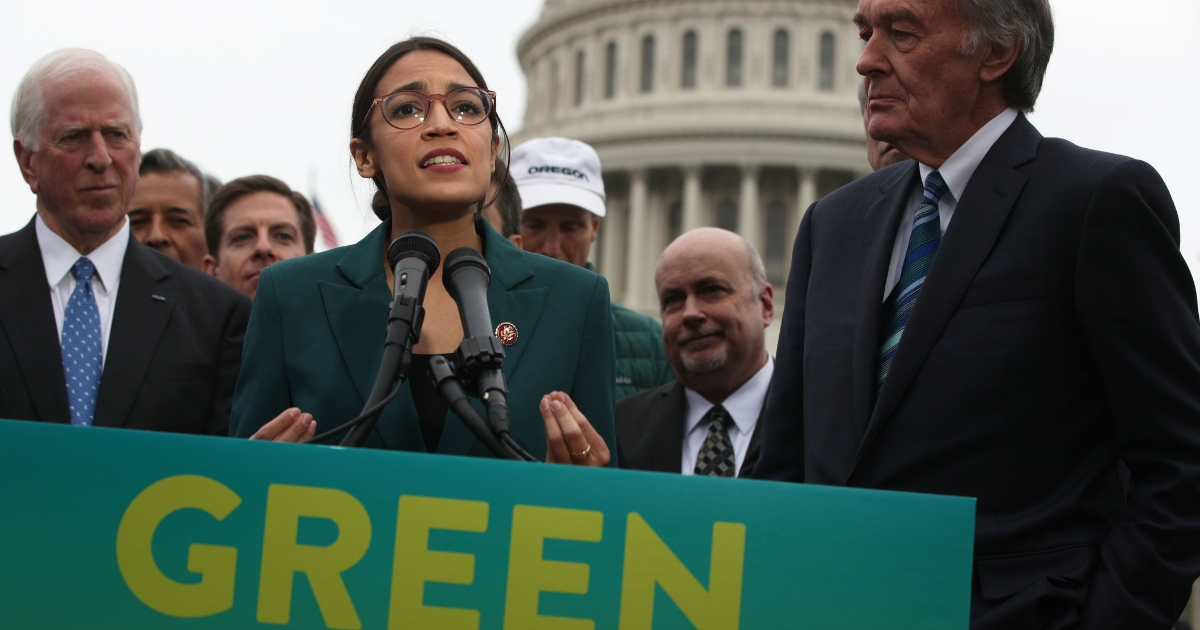 Rep. Alexandria Ocasio-Cortez (D-NY) speaks as Sen. Ed Markey (D-MA) (Right) and other Congressional Democrats listen during a news conference in front of the U.S. Capitol Feb. 7, 2019, in Washington, D.C.