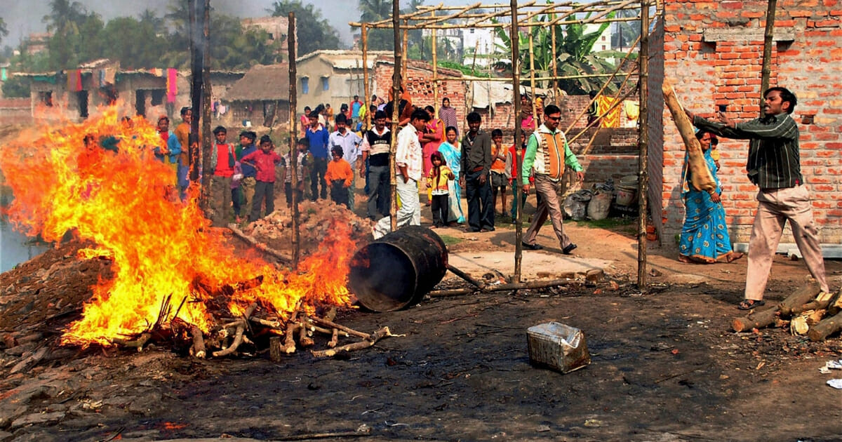 An illicit booze shop goes up in flames after it was set ablaze by villagers in Burdwan district of West Bengal state, India.