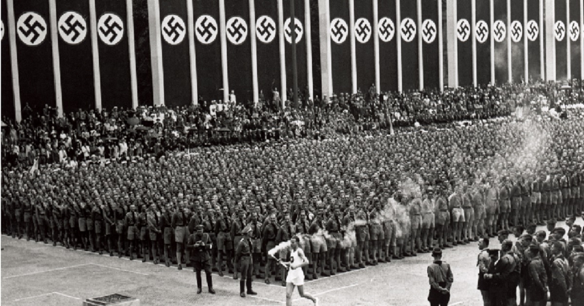 The Olympic torch is carried into the stadium during the opening ceremonies of the XI Olympic Games at the Olympic Stadium in Berlin, Germany, on Aug. 1, 1936.