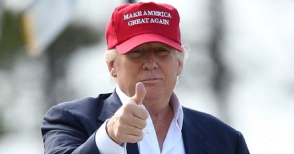 President Donald Trump wearing a "Make America Great Again" cap.