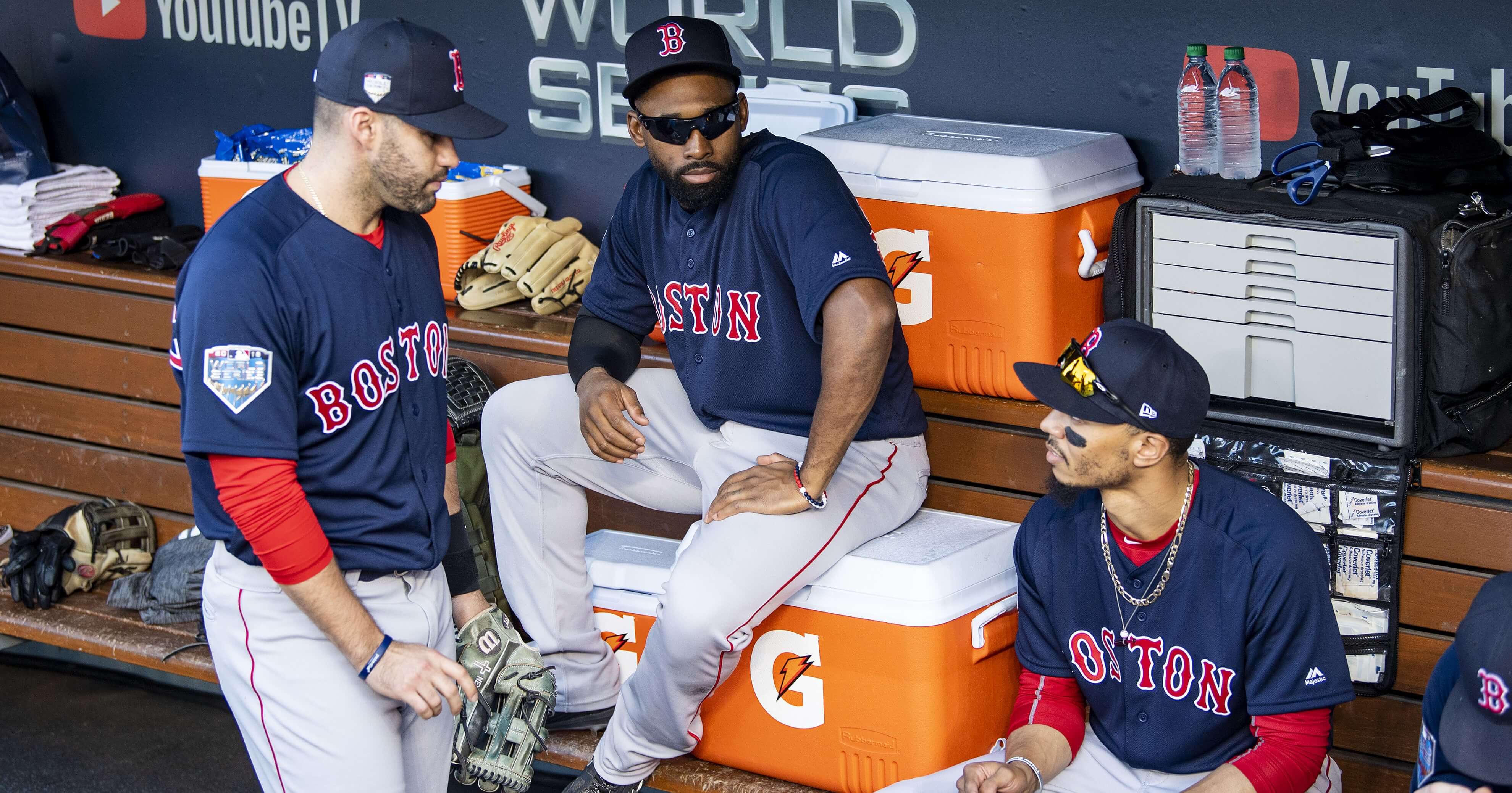 Jackie Bradley Jr., center, talks with Boston Red Sox teammates J.D. Martinez, left, and Mookie Betts before Game 3 of the 2018 World Series against the Los Angeles Dodgers on Oct. 26.