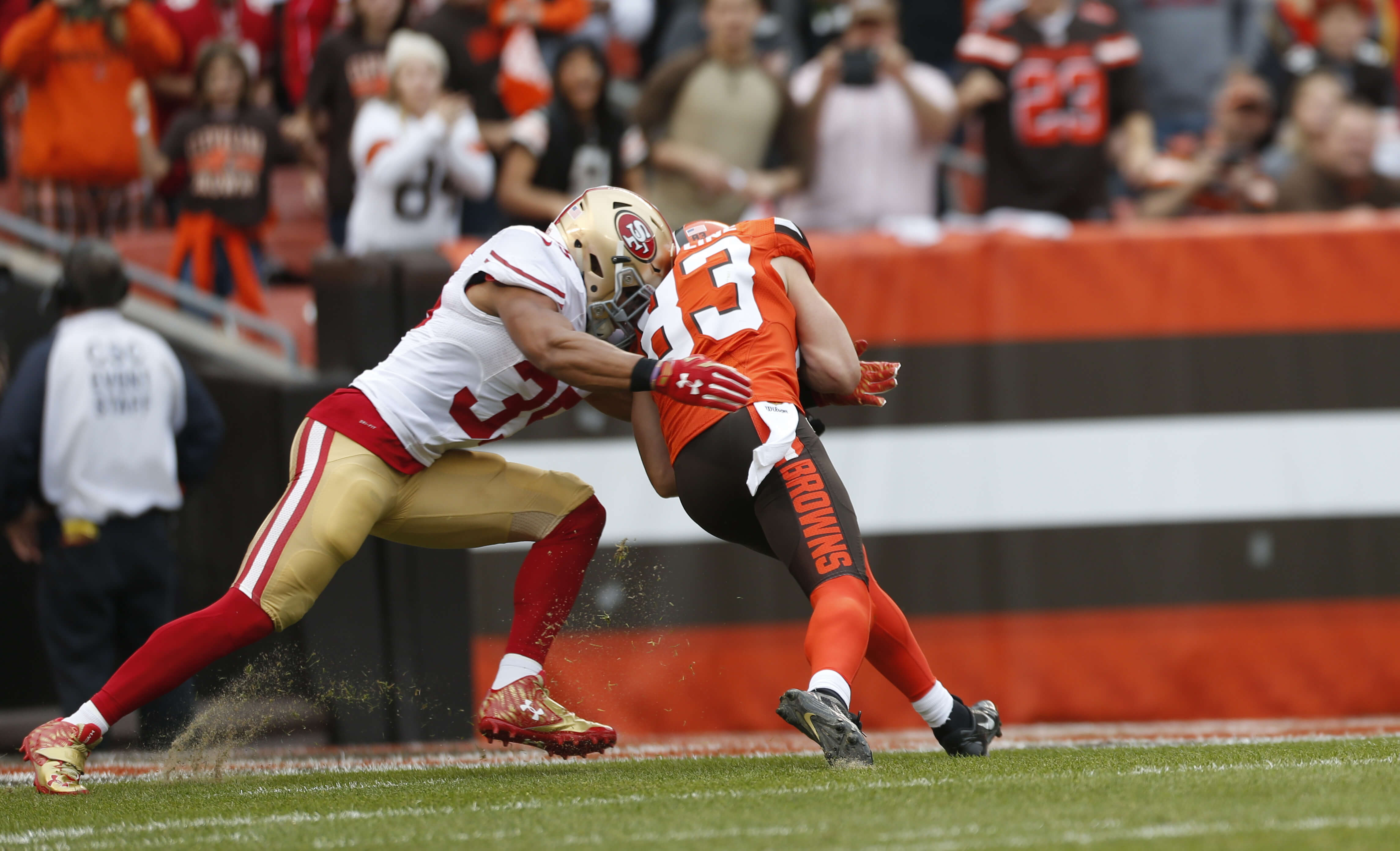 Brian Hartline #83 of the Cleveland Browns fumbles the ball after a big hit by Eric Reid #35 of the San Francisco 49ers during the game at Browns Stadium on Dec. 13, 2015 in Cleveland, Ohio. The Browns defeated the 49ers 24-10.