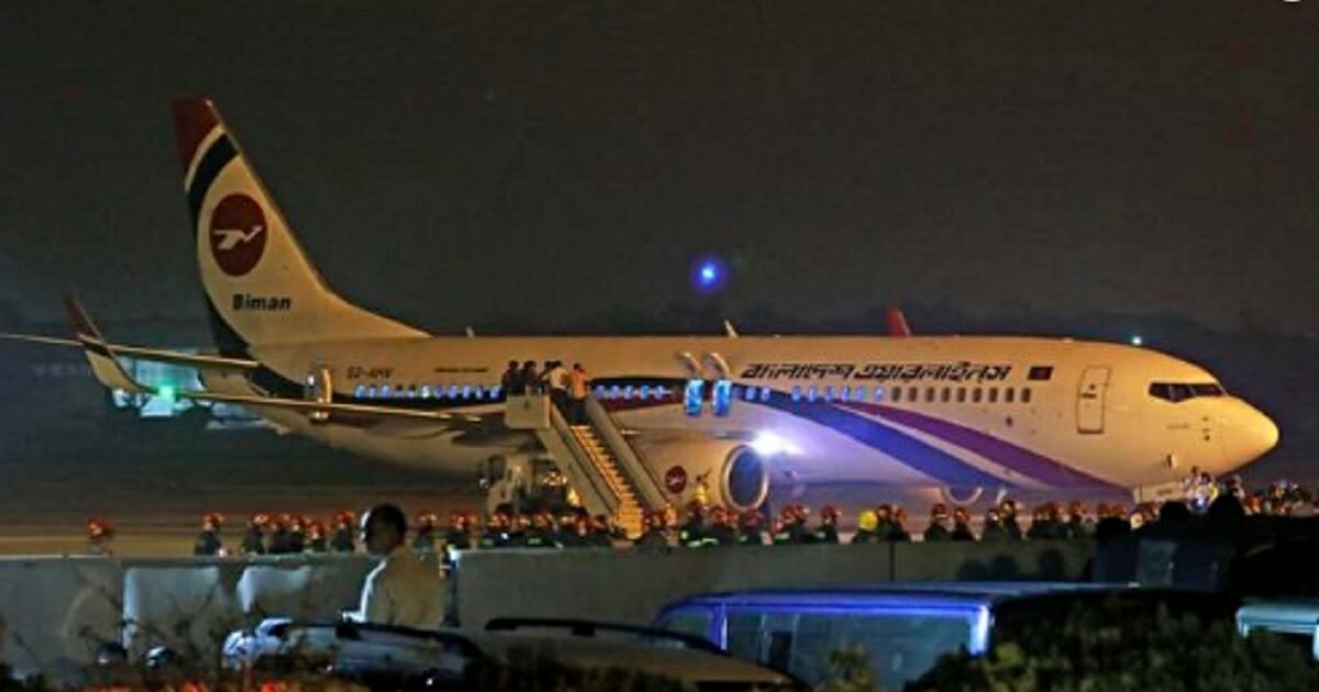 A Birman Bangladesh Airlines plane sits on an airport runway in Chittagong, Bangladesh, after making an emergency landing during a hijacking attempt.