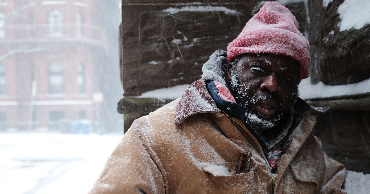 George, who is homeless, pauses in a church alcove, on the streets of Boston as snow falls from a massive winter storm on Jan. 4, 2018 in Boston, Massachusetts.