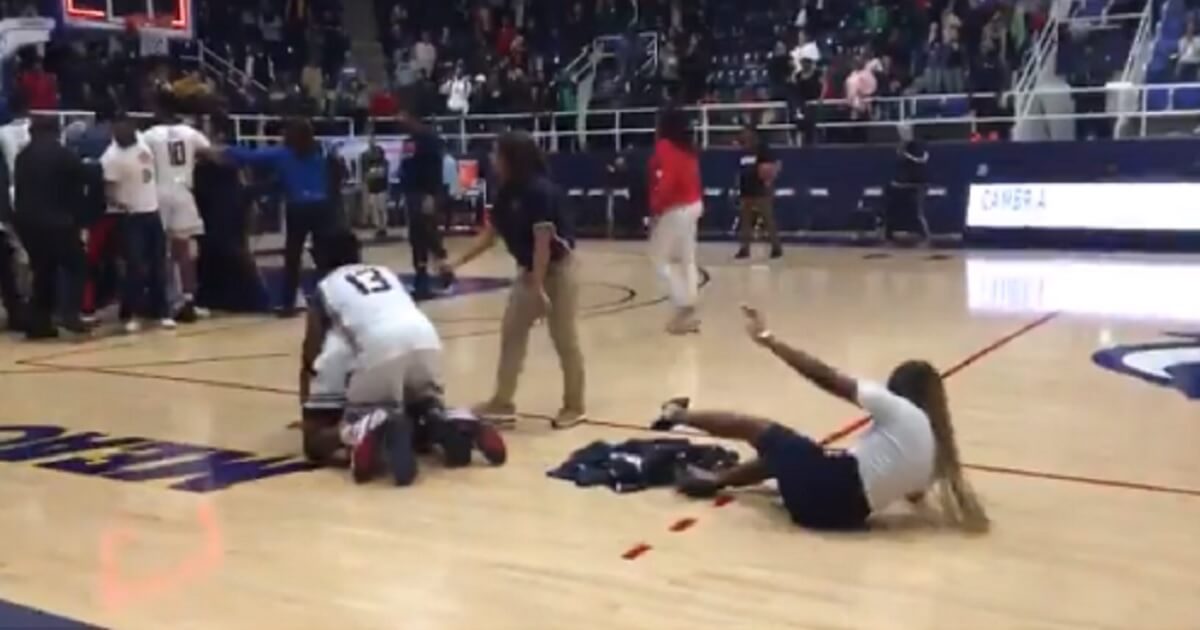 Players and staff sprawl on the court during the brawl.