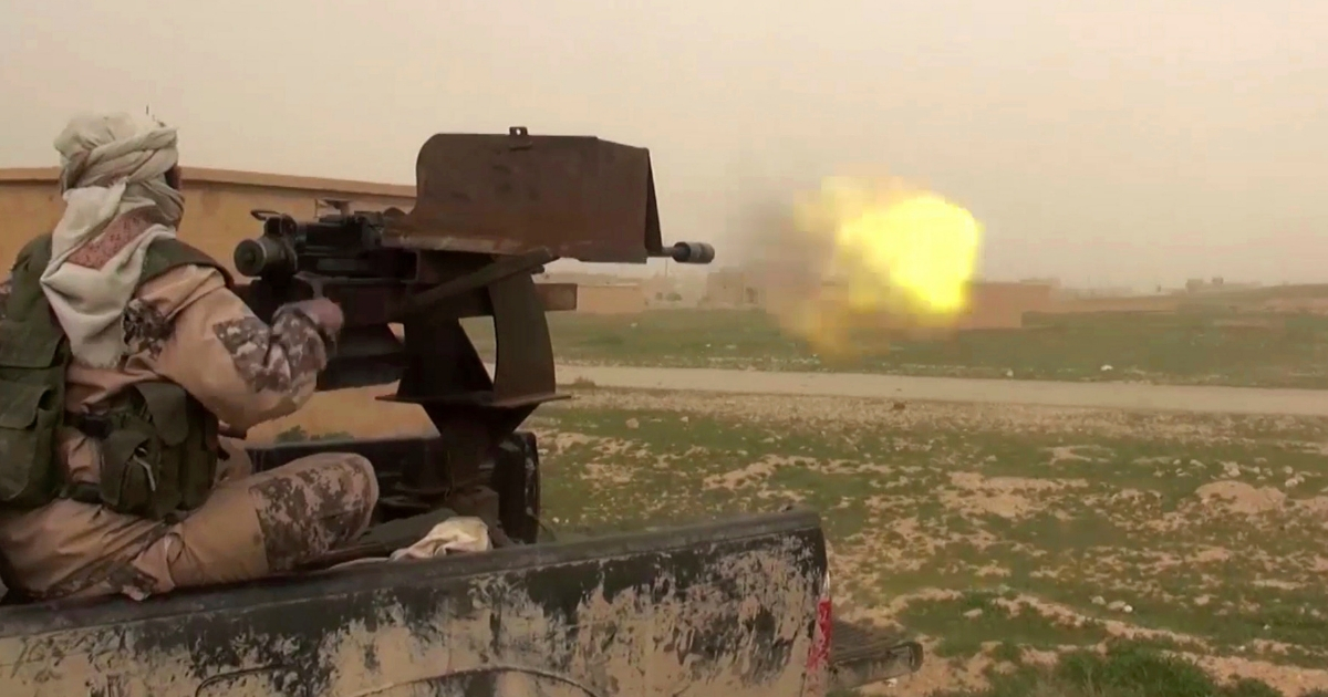 This frame grab from video posted online Jan. 18 by supporters of the Islamic State group purports to show a gun-mounted ISIS vehicle firing at members of the U.S.-backed Syrian Democratic Forces in the eastern Syrian province of Deir el-Zour, Syria.
