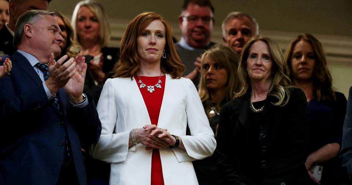 Jennie Taylor, wife of slain Utah National Guard Maj. Brent Taylor, and Tammy Taylor, Maj. Taylor's mother, stand as the House chamber audience rises to honor the families of Utahns who fell in the line of duty in the last year during Utah Gov. Gary Herbert's State of the State address.