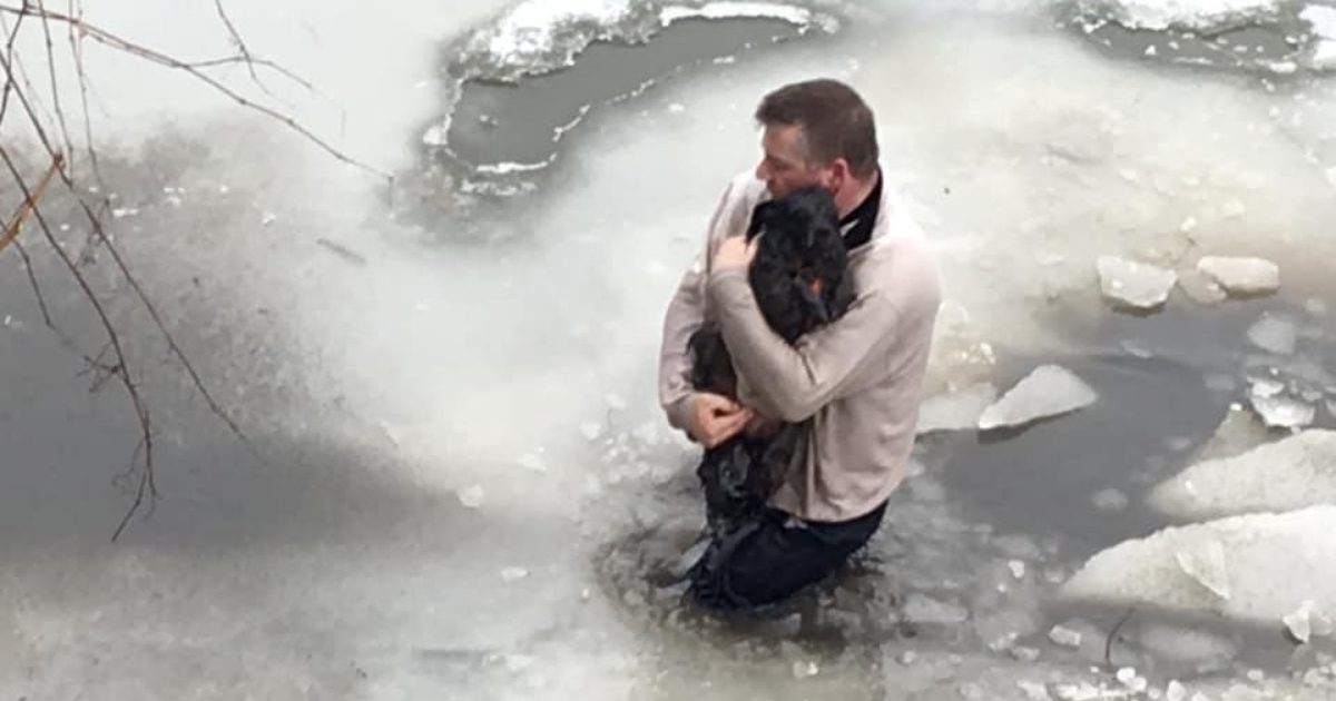 Man wades through icy water to rescue pup.