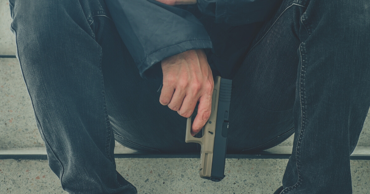 Man with Gun Sitting