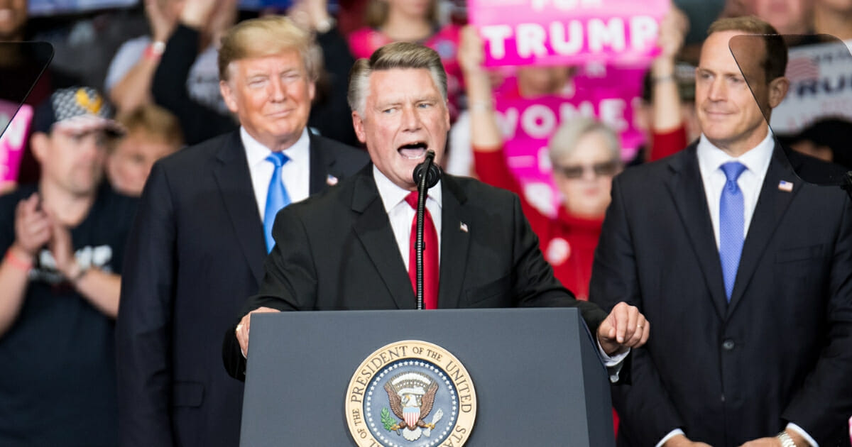 Republican Congressional candidate for North Carolina's 9th district Mark Harris (C), addresses the crowd as President Donald Trump (L) and Republican Congressional candidate for North Carolina's 13th district Ted Budd (R), listen at the Bojangles Coliseum on Oct. 26, 2018, in Charlotte, North Carolina.