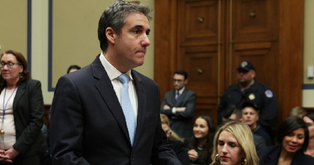Former Donald Trump attorney Michael Cohen returns from a break Wednesday while testifying before the House Committee on Oversight and Government Reform.