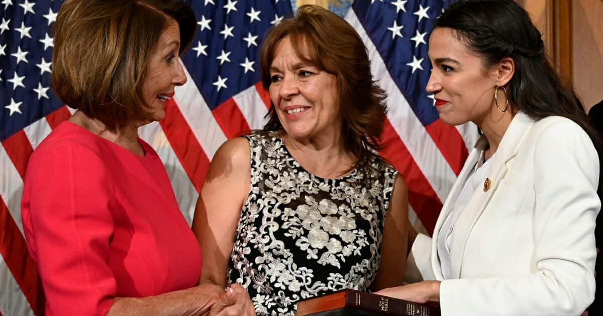 House Speaker Nancy Pelosi, left, talks with Rep. Alexandria Ocasio-Cortez, right, and her mother Blanca Ocasio-Cortez, center, during a ceremonial swearing-in on Capitol Hill in Washington on Jan. 3.