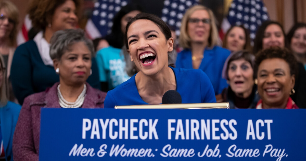 Rep. Alexandria Ocasio-Cortez, D-N.Y., smiles as she speaks at an event to advocate for the Paycheck Fairness Act.