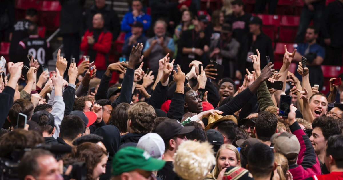 San Diego State students and fans rushed the court after the Aztecs upset No. 6 Nevada.
