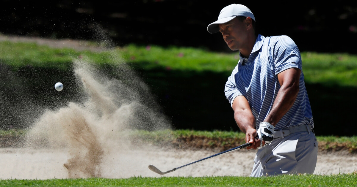 Tiger Woods hits from a sand trap on the first day of competition of the WGC-Mexico Championship at the Chapultepec Golf Club in Mexico City on Thursday.