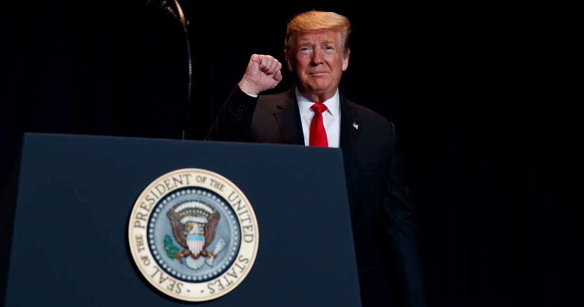 President Donald Trump pumps his fist as he arrives for the National Prayer Breakfast, Feb. 7, 2019, in Washington.
