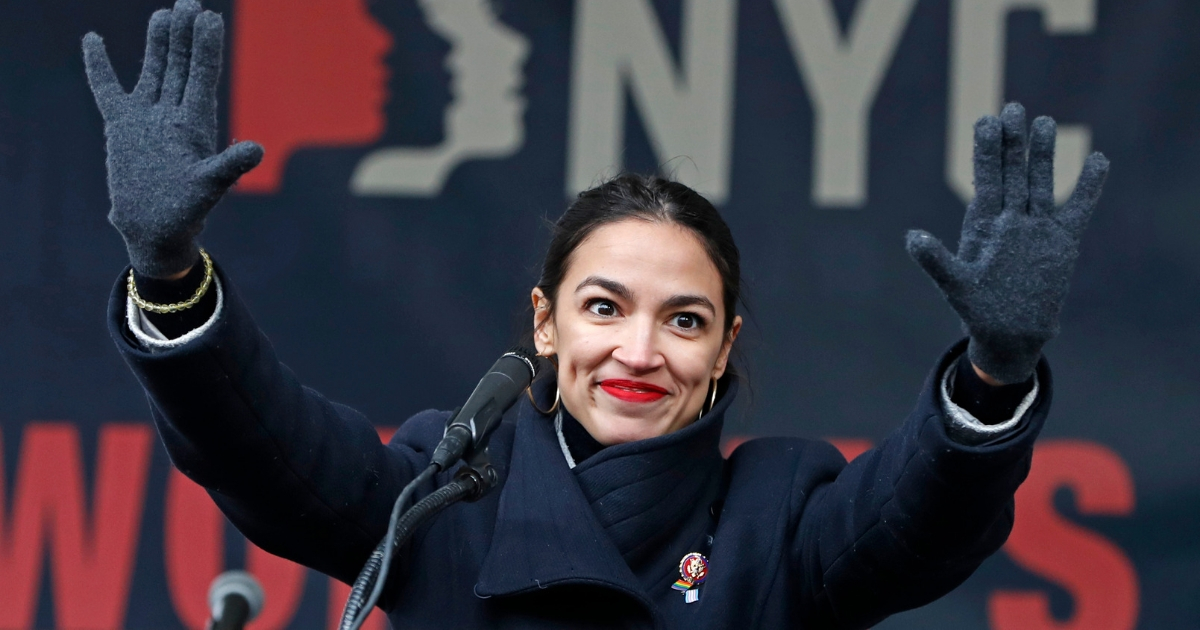 U.S. Rep. Alexandria Ocasio-Cortez, D-N.Y., waves to the crowd after speaking at the Women's Unity Rally in Lower Manhattan in New York.