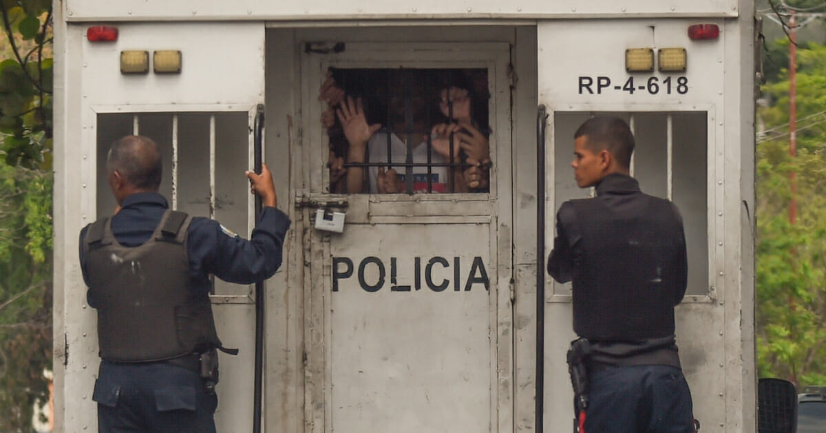 Police agents transport surviving prisoners after police holding cells caught fire in Valencia, northern Carabobo state, Venezuela, on March 29, 2018. A total of 68 people died on Wednesday during an attempted jailbreak in Venezuela after a fire engulfed police holding cells in one of the worst tragedies in years in a notoriously violent and overcrowded prison system.
