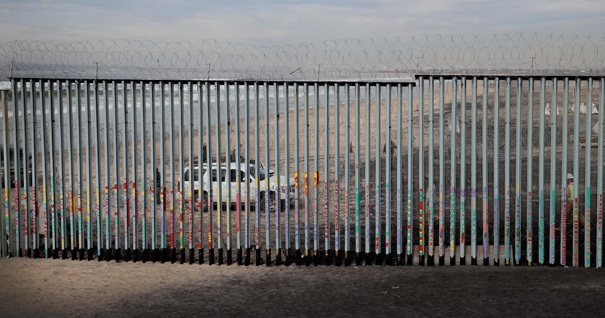 U.S. border patrol agents stand watch across the border where the border wall that separates the U.S. and Mexico meets the Pacific Ocean on Jan. 28, 2019, in Tijuana, Mexico.