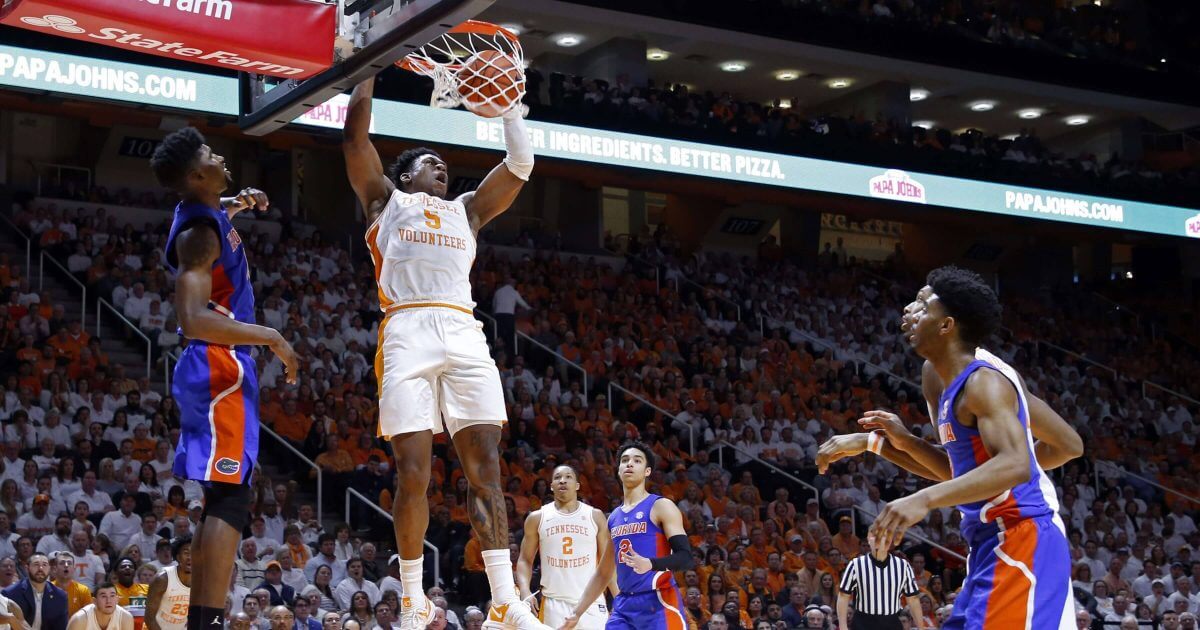 Tennessee guard Admiral Schofield (5) dunks the ball in front of Florida center Kevarrius Hayes (13) during the second half of an NCAA college basketball game on Saturday in Knoxville, Tennessee. The Volunteers won 73-61.