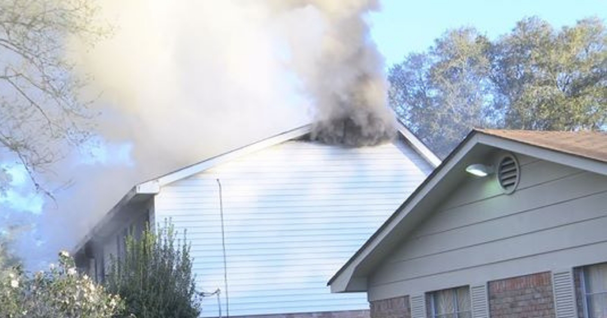 House with smoke coming out of it.