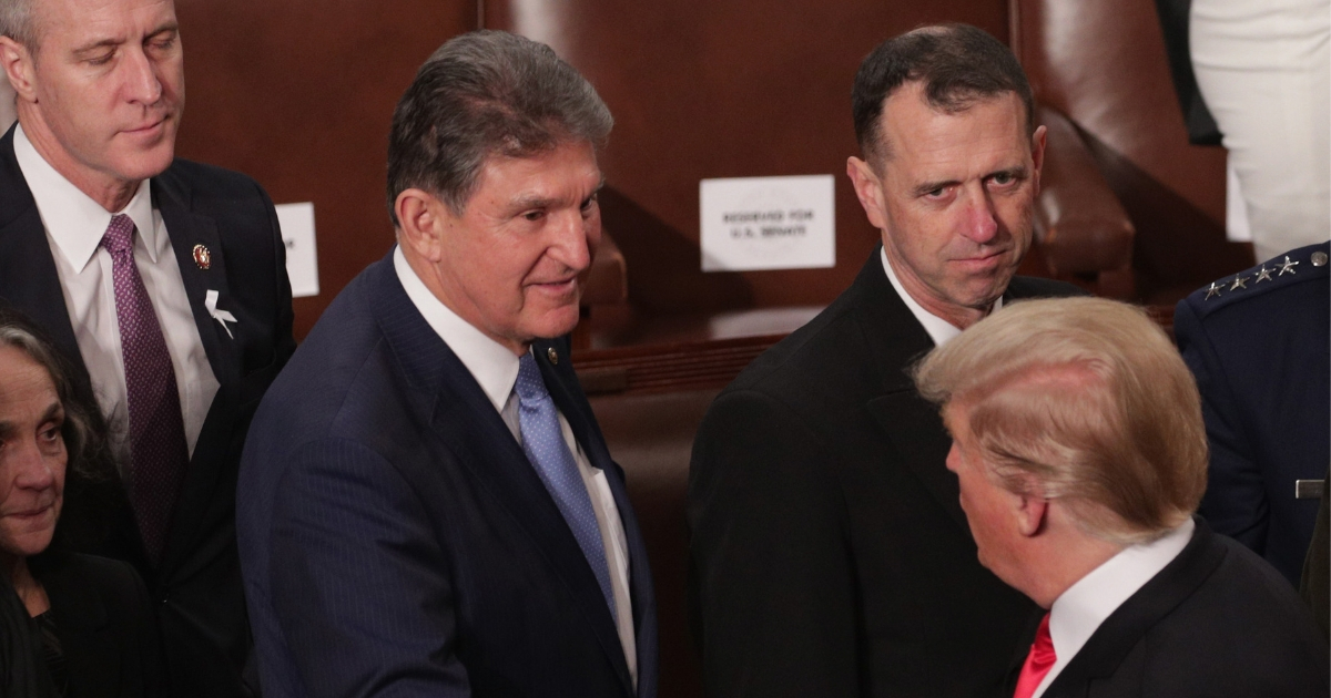 President Donald Trump greets Democratic Sen. Joe Manchin of West Virginia after the State of the Union address.
