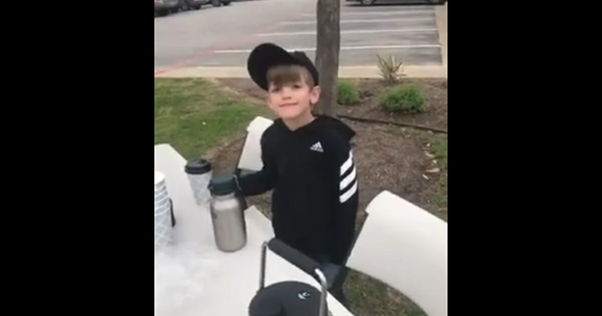 Little boy selling hot chocolate
