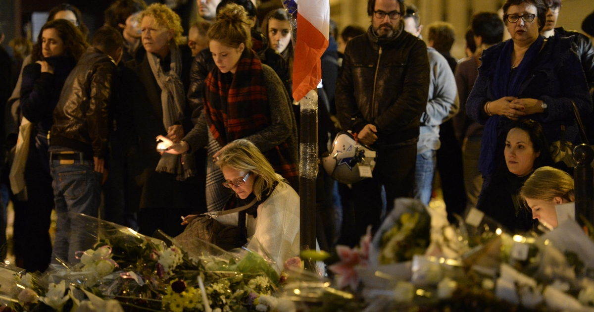 People lay flowers and candles outside Le Carillon cafe at the site of the attacks in Paris, on Nov. 16, 2015 in tribute to the victims of the attacks claimed by Islamic State which killed at least 129 people and left more than 350 injured on Nov. 13.