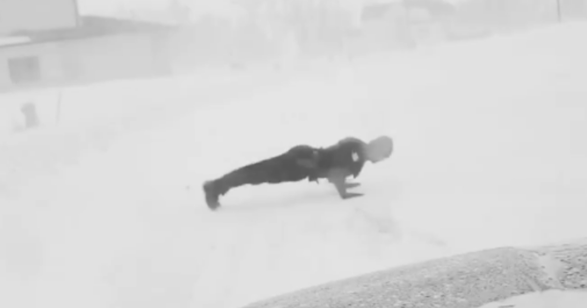 Police officer does pushups in the snow