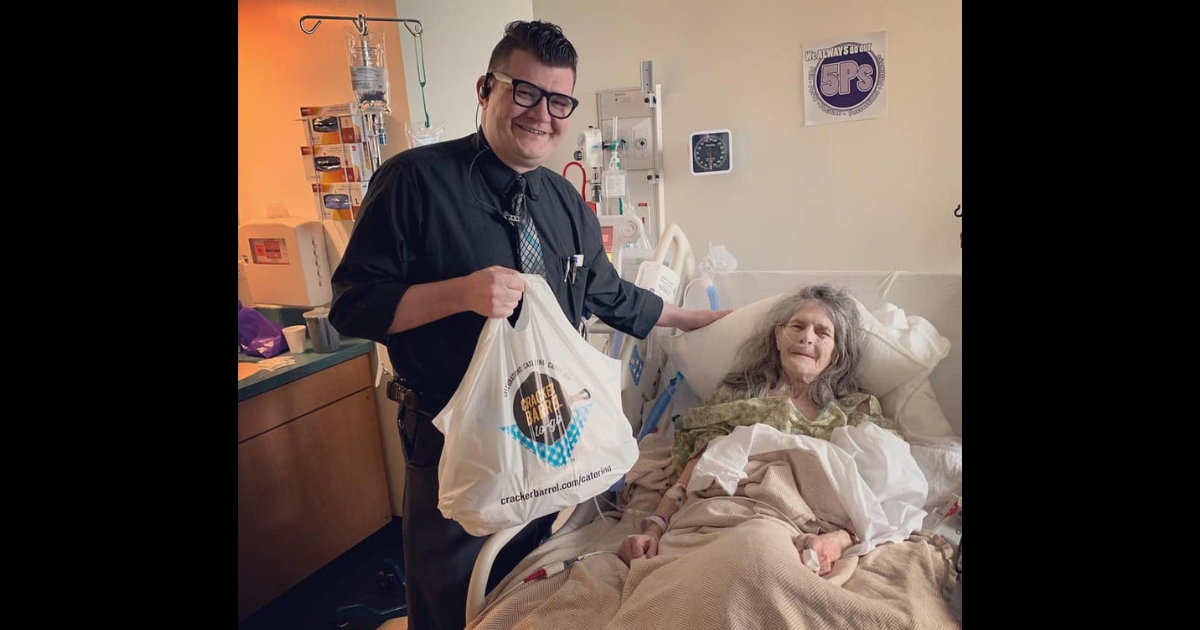 General manager delivers cake to woman in hospital.