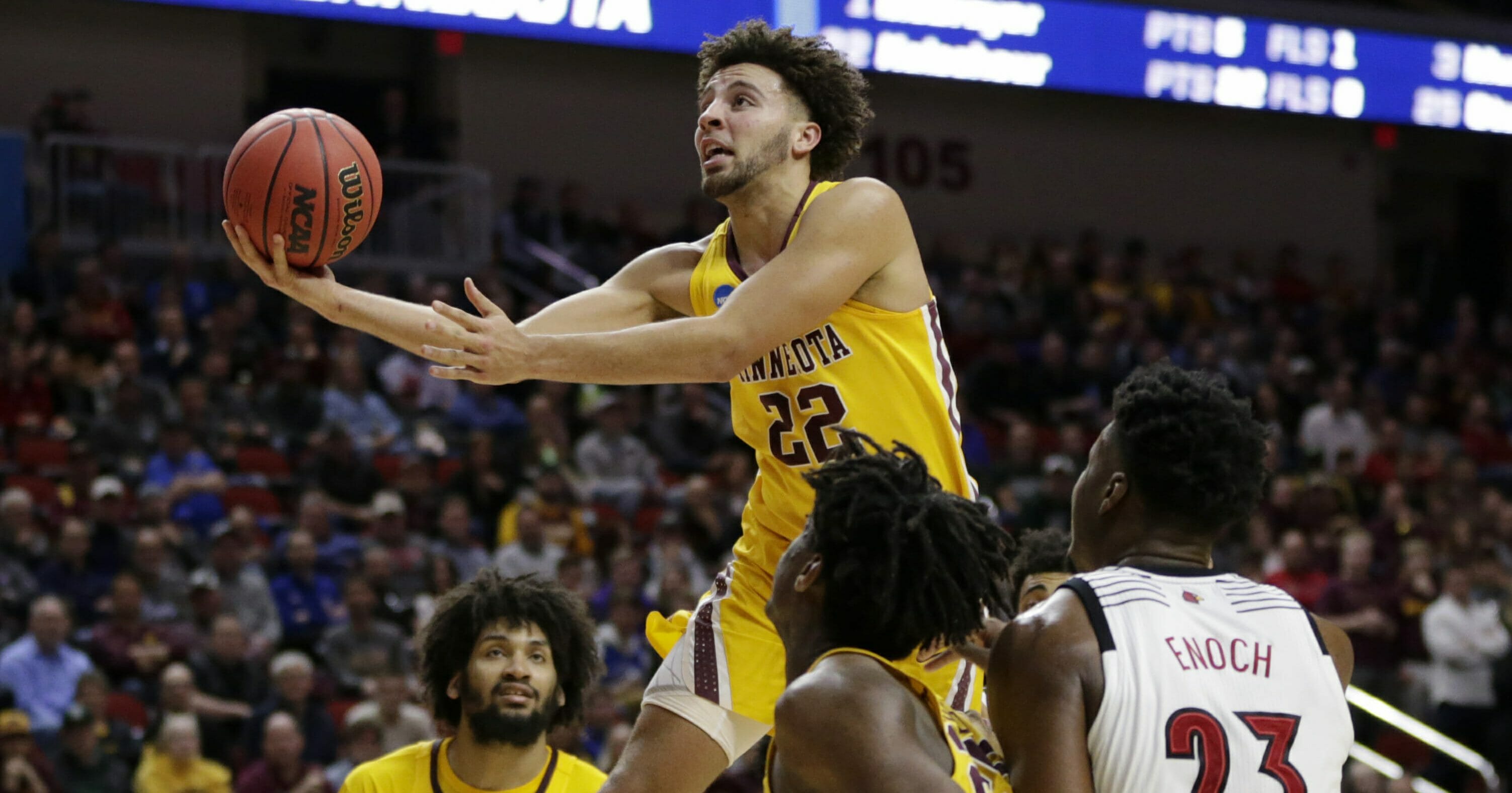 Minnesota's Gabe Kalscheur goes for a layup as Louisville's Steven Enoch watches their first-round NCAA Tournament game March 21, 2019, in Des Moines, Iowa.