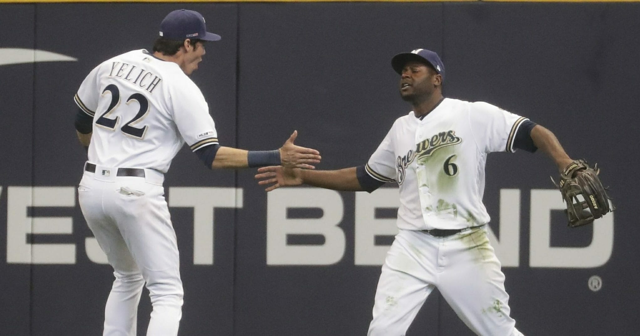 The Milwaukee Brewers' Lorenzo Cain, right, is congratulated by Christian Yelich