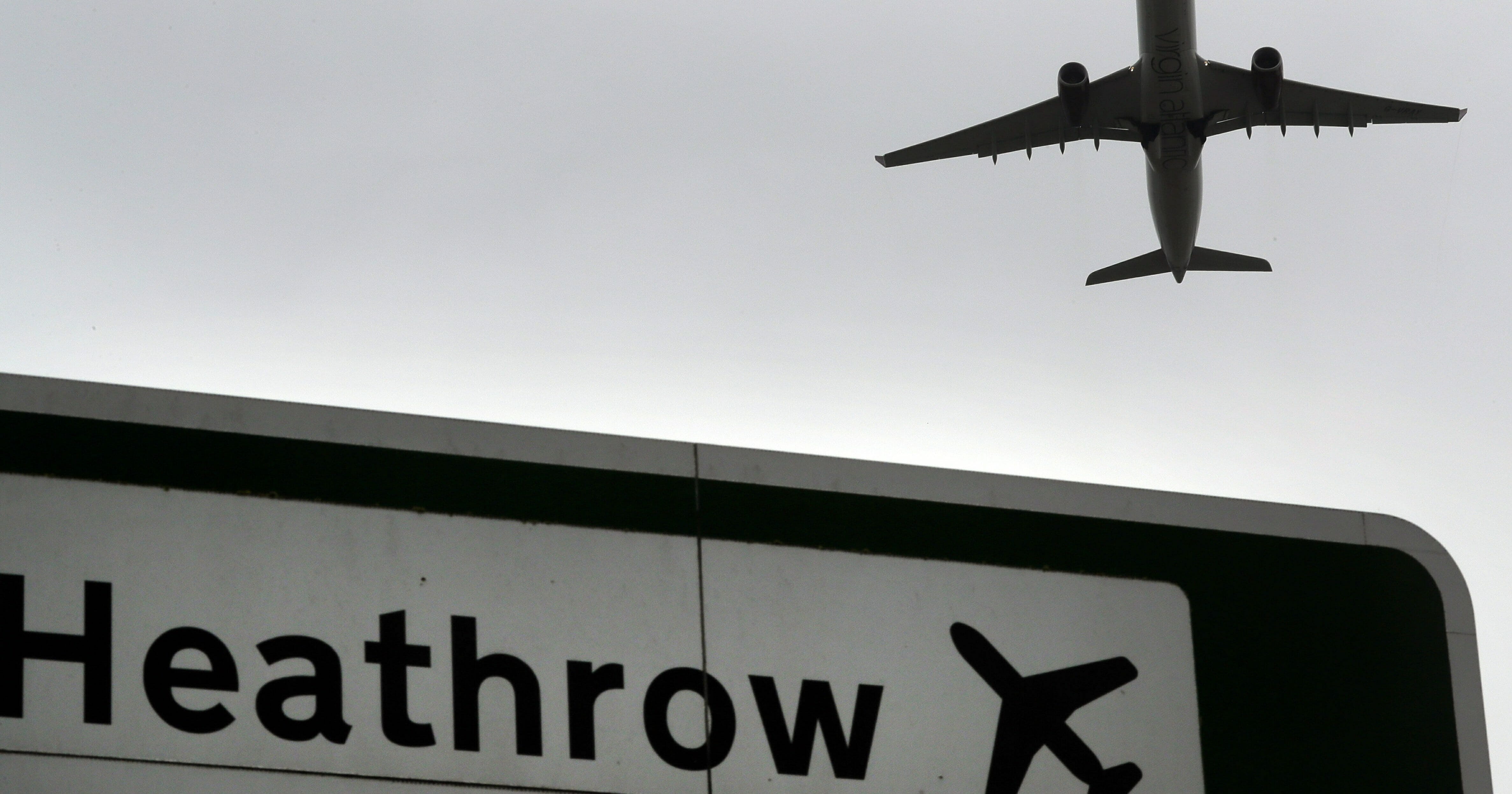 A jet takes off over a road sign near Heathrow Airport in London on June 5, 2018.