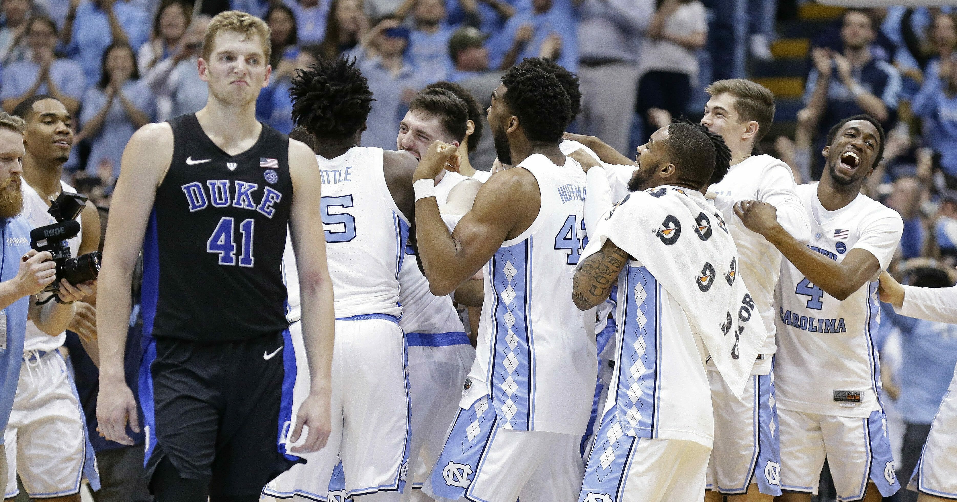 North Carolina players celebrate while Duke's Jack White walks away following an NCAA college basketball game in Chapel Hill, N.C., Saturday, Mar. 9, 2019.